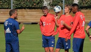 Michael Cuisance und Jann-Fiete Arp im Gespräch mit Trainer Hansi Flick.